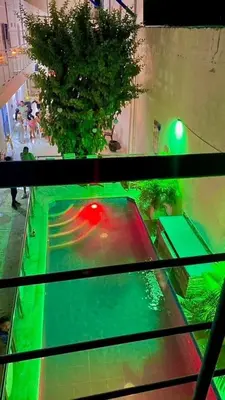 a bowling alley with a red ball in a pool at Habitación luxury villa oti in Ciénaga