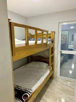 two bunk beds in a room with a mirror at Habitación luxury villa oti in Ciénaga