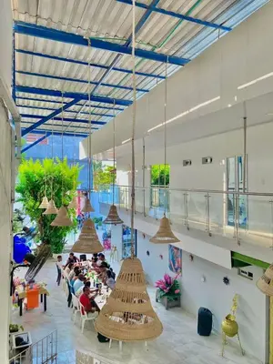 a room with people sitting at tables in a building at Habitación luxury villa oti in Ciénaga