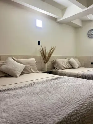 two beds sitting next to each other in a room at Kiimala Villas y Hotel in Puerto Viejo