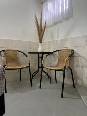 two chairs and a table with a vase on it at Kiimala Villas y Hotel in Puerto Viejo