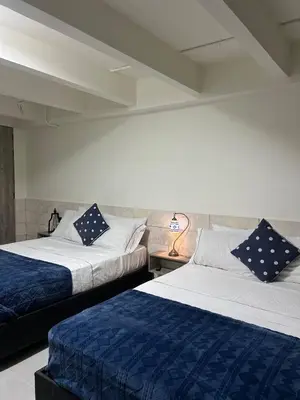 two beds sitting next to each other in a room at Kiimala Villas y Hotel in Puerto Viejo