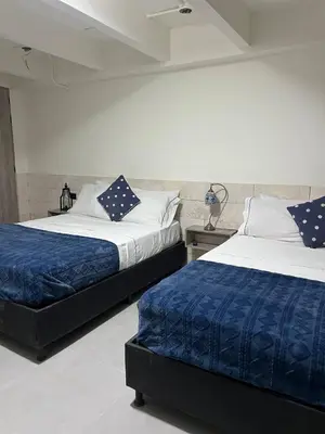 two beds sitting next to each other in a bedroom at Kiimala Villas y Hotel in Puerto Viejo