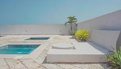 a patio with a pool and a couch and a swimming pool at OD805 Acogedor Vista al Mar Piscina Vista Infinita in Cartagena de Indias
