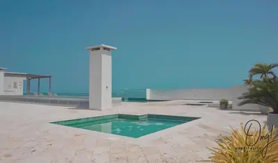 a swimming pool in the middle of a patio near the ocean at OD805 Acogedor Vista al Mar Piscina Vista Infinita in Cartagena de Indias