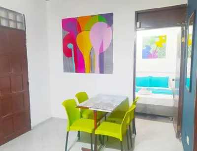 a dining room with a table and chairs and a painting at Apartamento centro historico 209 in Cartagena de Indias