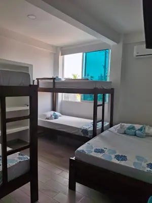 two bunk beds in a room with a window at Cabañas Ana Sofía in San Antero