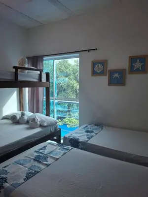 two bunk beds in a room with a window at Cabañas Ana Sofía in San Antero