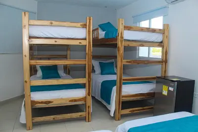 a bedroom with two bunk beds with blue pillows at Ledymar Chalet in Cartagena de Indias