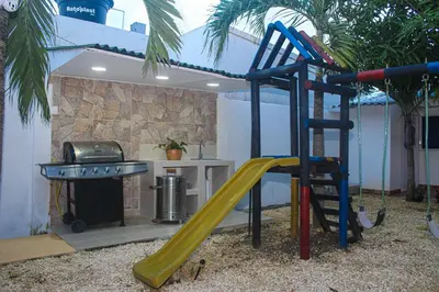 a playground with a slide and a grill at Ledymar Chalet in Cartagena de Indias