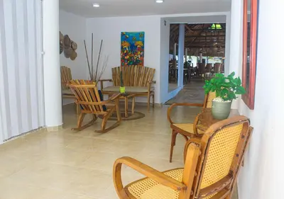 a dining room with chairs and a table with a plant at Ledymar Chalet in Cartagena de Indias