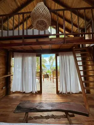 a room with a bunk bed in a cabin at Entre Palmas Cabañas in Moñitos