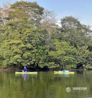 a man sitting on a kayak in the water at Apartamentos Mila in Guayabal