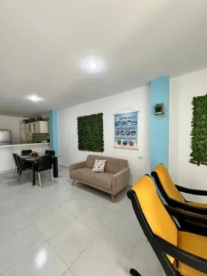 a living room with a couch and a table at Apartamentos Mila in Guayabal