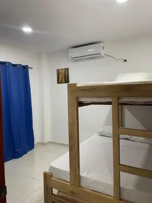 a room with two bunk beds and a projector at Apartamentos Mila in Guayabal