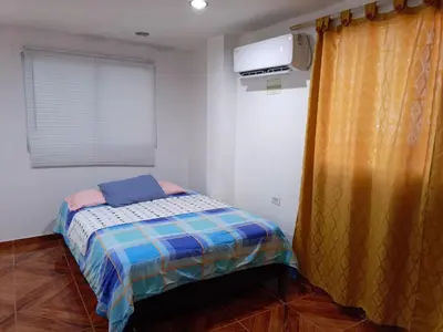 a small bedroom with a bed and a television at Apartamento Familiar para 6 personas in Cartagena de Indias