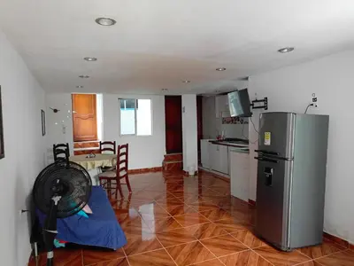 a kitchen with a refrigerator and a table with chairs at Apartamento Familiar para 6 personas in Cartagena de Indias