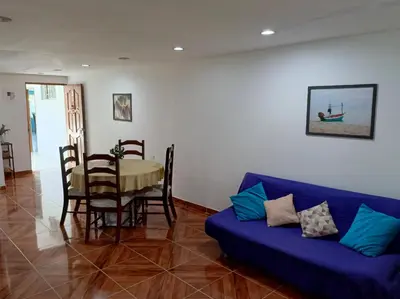 a living room with a blue couch and a table at Apartamento Familiar para 6 personas in Cartagena de Indias