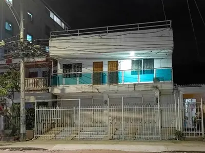 a white house with a fence in front of it at Apartamento Familiar para 6 personas in Cartagena de Indias