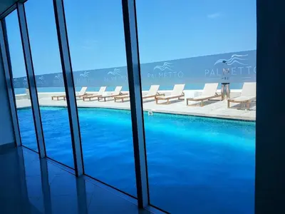 a view of a swimming pool from inside a building at Lujo frente a la playa in Cartagena de Indias