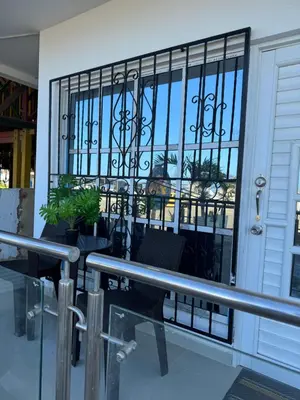 a room with a door and a window with chairs at Apartamentos el mochilero frente a la playa piso 1 apto 2 in Cartagena de Indias