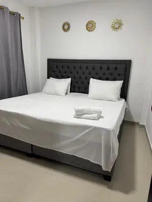 a bed with two towels on it in a room at Apartamentos el mochilero frente a la playa piso 1 apto 2 in Cartagena de Indias