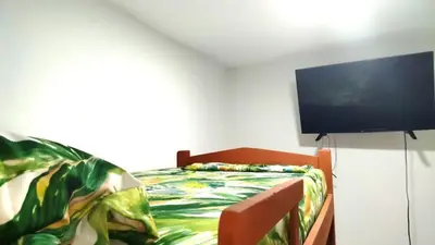 a bedroom with a bed and a flat screen tv at Hospedaje Doña Argenida in Cartagena de Indias