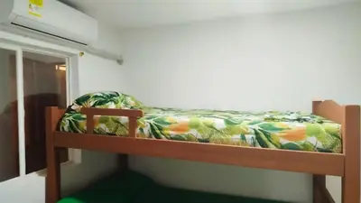 a bunk bed in a room with a green and orange bed at Hospedaje Doña Argenida in Cartagena de Indias