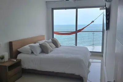 a bedroom with a bed with a view of the ocean at Apartamento Boutique - Cartagena in Cartagena de Indias