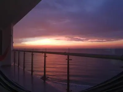 a view of the ocean at sunset from a cruise ship at Apartamento Boutique - Cartagena in Cartagena de Indias