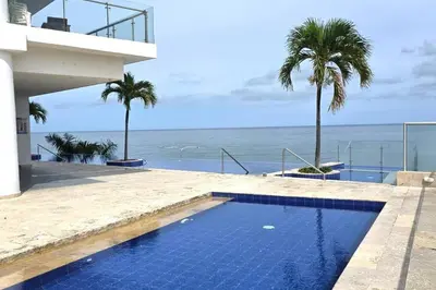 a swimming pool with a view of the ocean at Apartamento Boutique - Cartagena in Cartagena de Indias