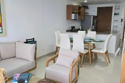 a living room with a table and white chairs at Apartamento Boutique - Cartagena in Cartagena de Indias