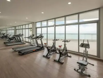 a gym with a row of treadmills and exercise bikes at Apartamento Boutique - Cartagena in Cartagena de Indias
