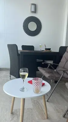 a white table with a glass of wine on it at Aparta suite Fantástique in Cartagena de Indias