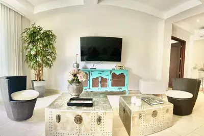 a living room with a tv and a table at Modern Comfort - Spacious 2BR in Walled City in Cartagena de Indias