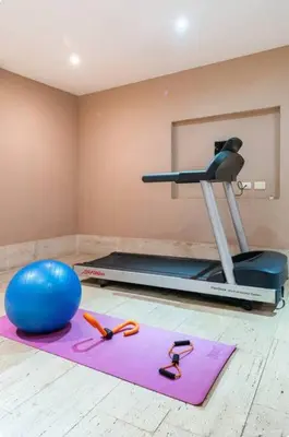 a room with a gym with a yoga ball and a treadmill at Modern Comfort - Spacious 2BR in Walled City in Cartagena de Indias