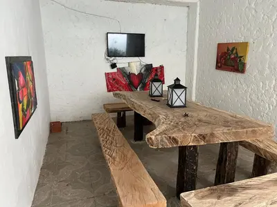 a dining room with wooden tables and a tv on the wall at Casa Torices Real 12 in Cartagena de Indias