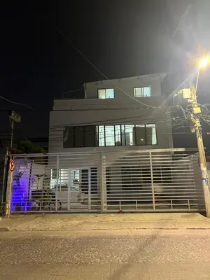 a white building with a fence in front of it at Casa Torices Real 12 in Cartagena de Indias