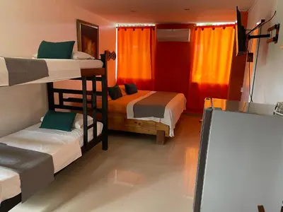 a room with two bunk beds and a chalkboard at Biohotel Caribe Green in Santa Marta