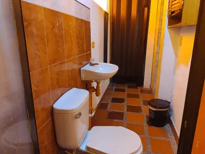 a bathroom with a toilet and a sink at Biohotel Caribe Green in Santa Marta