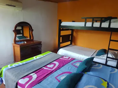 a bedroom with two bunk beds and a mirror at Biohotel Caribe Green in Santa Marta
