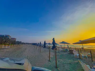a beach with a bunch of umbrellas and chairs at Alojamiento Serena Tu Casa en la Playa in Cartagena de Indias