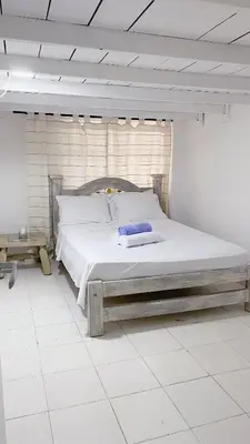 a bedroom with a large bed in a room at Apartaestudio in Old City Cartagena apto 2C in Cartagena de Indias