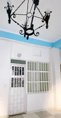 a chandelier hangs over a white garage door at Apartaestudio in Old City Cartagena apto 2C in Cartagena de Indias