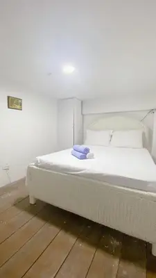 a white bed with a blue towel sitting on it at Apartaestudio in Old City Cartagena apto 2C in Cartagena de Indias
