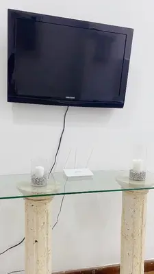 a tv on top of a glass table with two candles at Apartaestudio in Old City Cartagena apto 2C in Cartagena de Indias