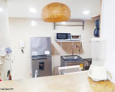 a kitchen with a refrigerator and a counter top at Apartamento Piso 9 Vista al Mar in Cartagena de Indias