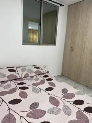 a bedroom with a bed with a brown and white blanket at Rincón sereno barranquilla in Barranquilla