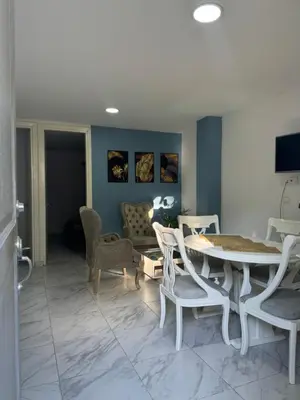 a living room with a table and chairs and a couch at Rincón sereno barranquilla in Barranquilla
