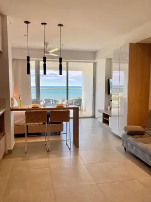 a living room with a table with a view of the ocean at Suite moderna con vista al mar y parque CB 814 in Cartagena de Indias